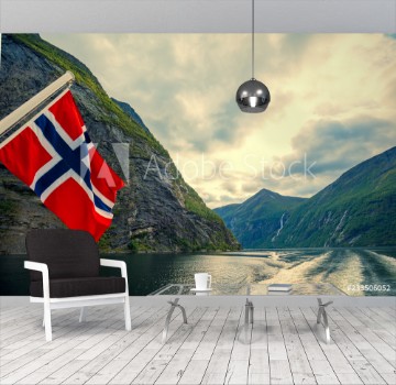 Bild på Mountain landscape with cloudy sky Majestic Geiranger fjord  View from ship Norvegian flag against beautiful nature of Norway